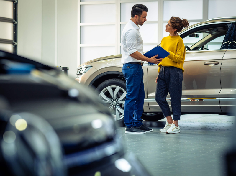 Volkswagen technician with customer