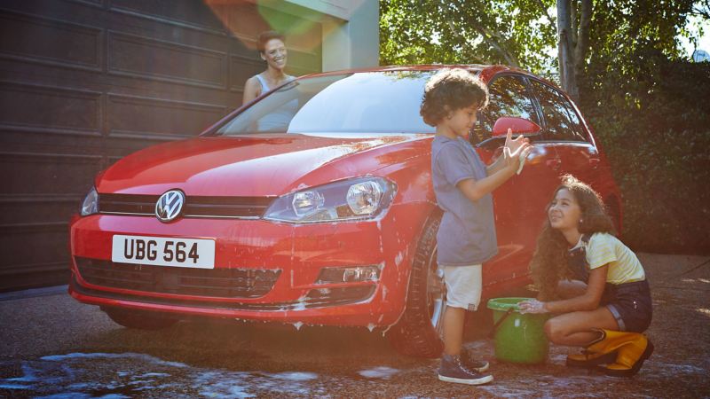 Family washing Volkswagen car