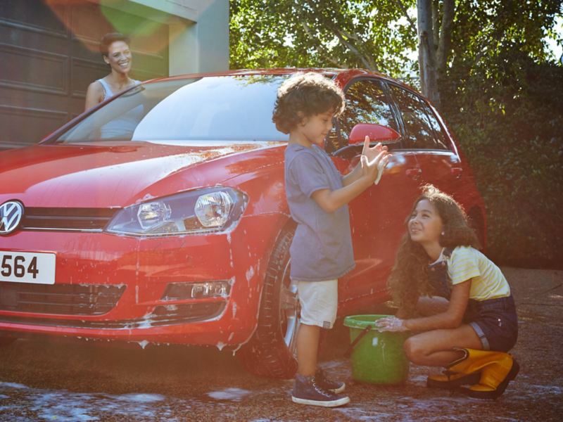 A family washing a VW Golf