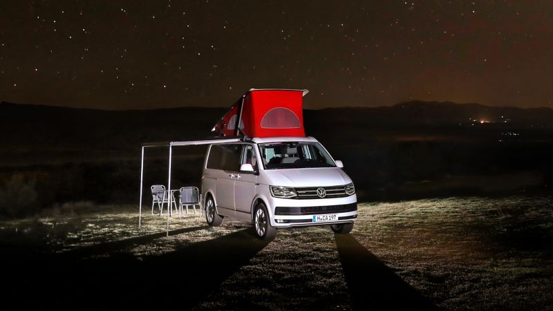 VW California camping under stars at night