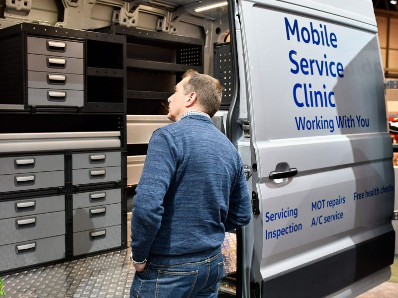 VW Mobile Service van with man looking inside van