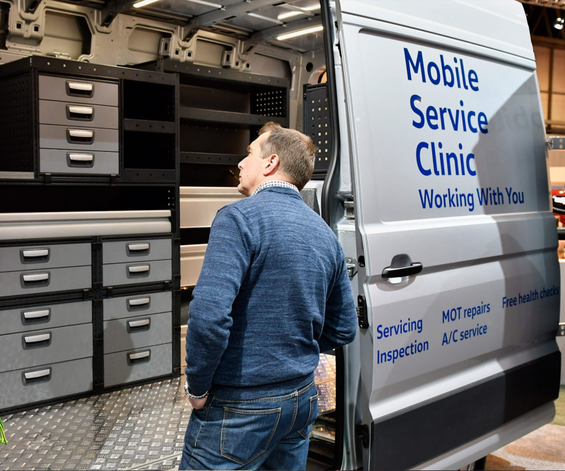 VW Mobile Service van with man looking inside van