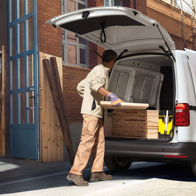Workmen securing load in a VW Caddy van
