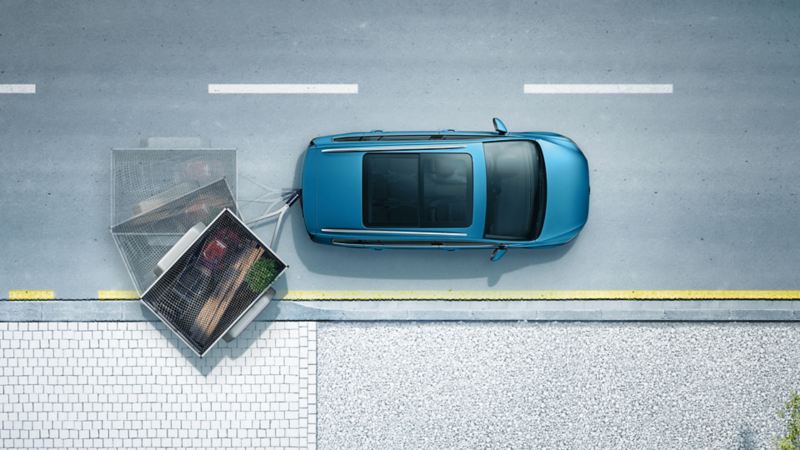 Rappresentazione grafica del funzionamento del pacchetto di assistenza alla guida 'Trailer Assist', per il trasporto con rimorchio, montato su una Volkswagen Touran vista dall'alto.