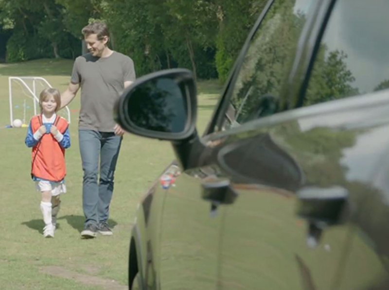 Man and child by car outside