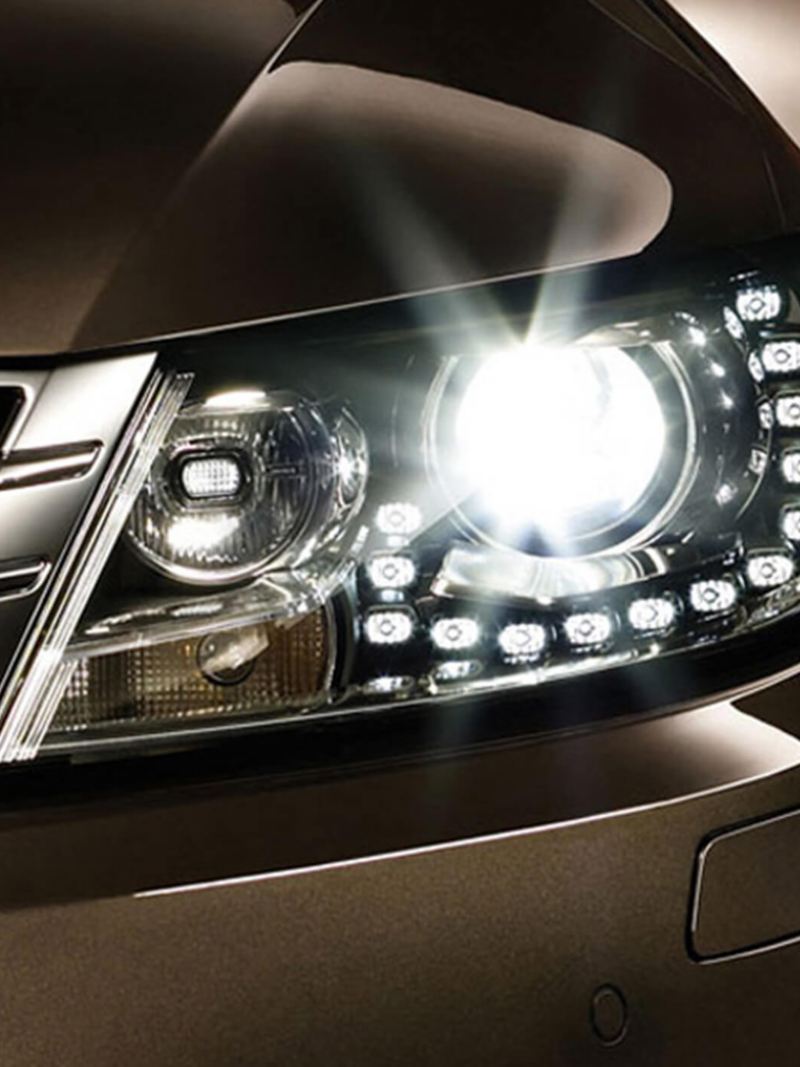 Front left headlight shot of a bronze Volkswagen CC.