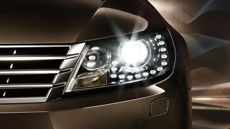 Front left headlight shot of a bronze Volkswagen CC.