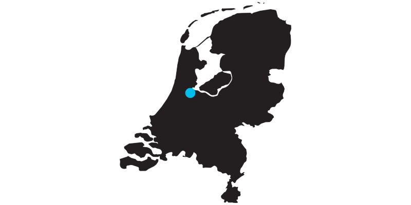 Outline of a map of the Netherlands with a mark on the location of Amsterdam