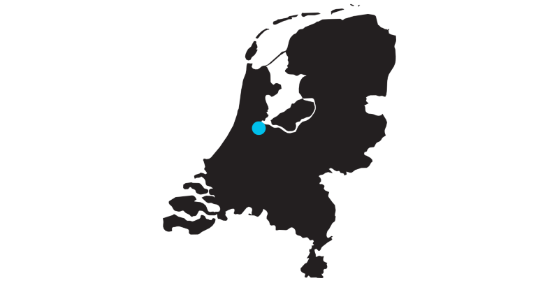 Outline of a map of the Netherlands with a mark on the location of Amsterdam