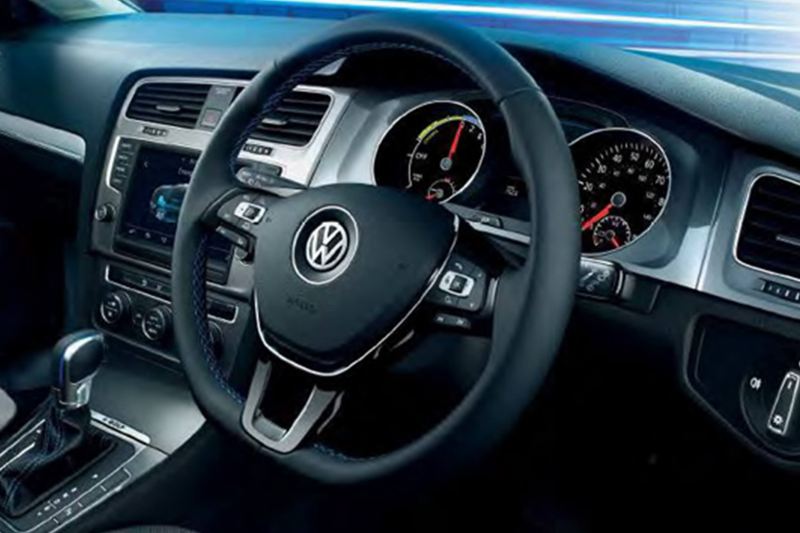 Interior shot of a Volkswagen e-Golf, steering wheel and dashboard.