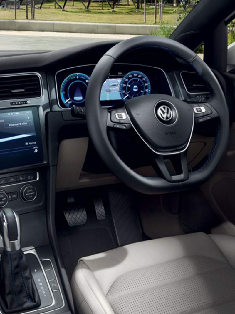 Interior shot of a Volkswagen e-Golf, steering wheel and dashboard.