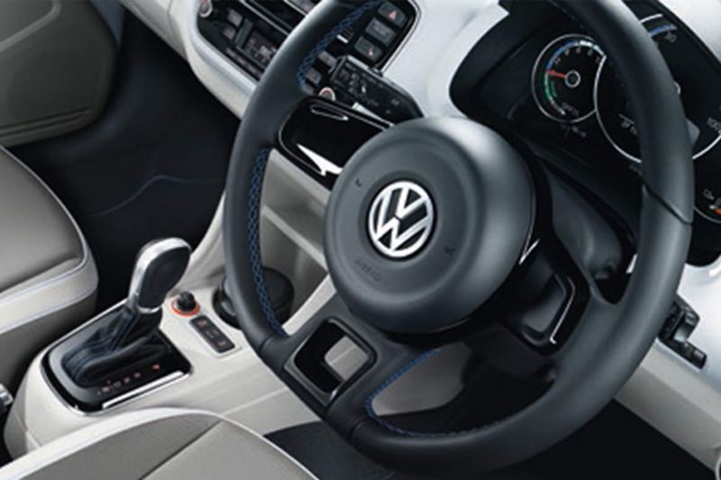 Interior shot of a Volkswagen e-up! steering wheel and dashboard.