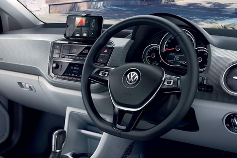 Interior shot of a Volkswagen e-up! steering wheel and dashboard.