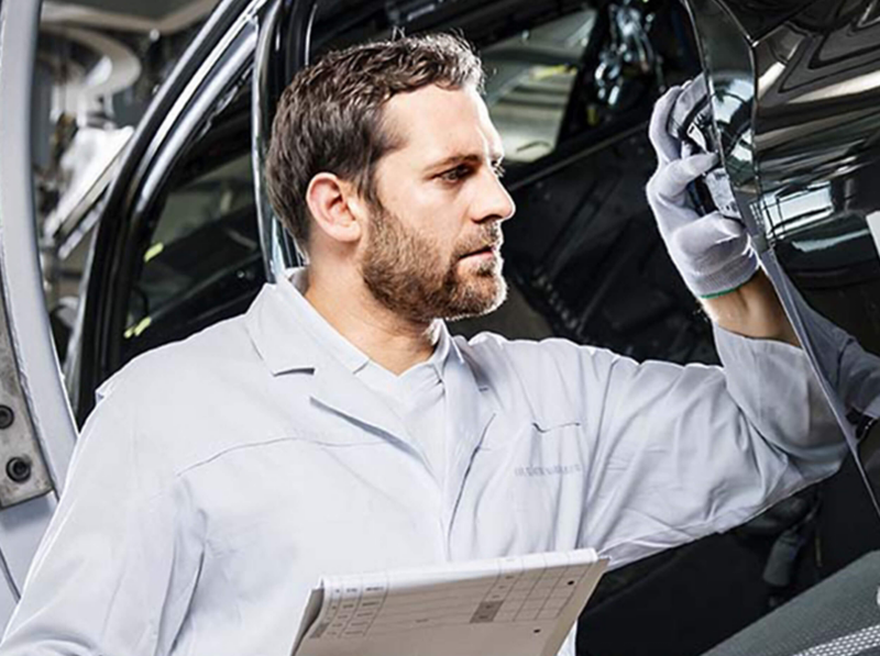 A technician looking at an engine