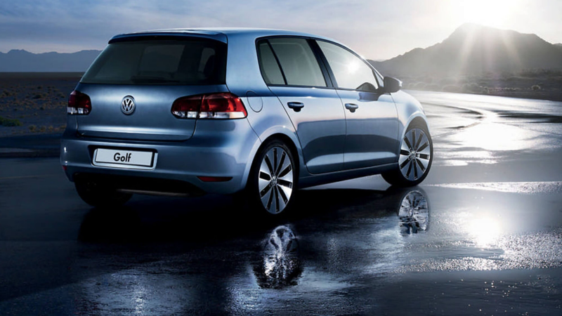 Rear shot of a blue Volkswagen Golf S, on a wet beach.