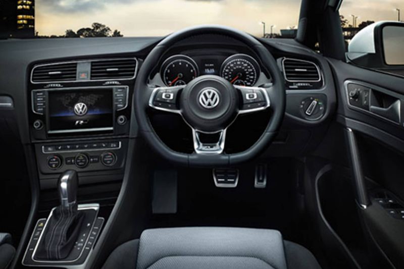 Interior shot of a Volkswagen Golf, steering wheel and dashboard.