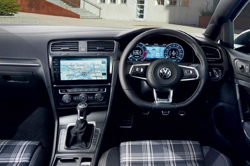 Interior shot of a Volkswagen Golf, steering wheel and dashboard.