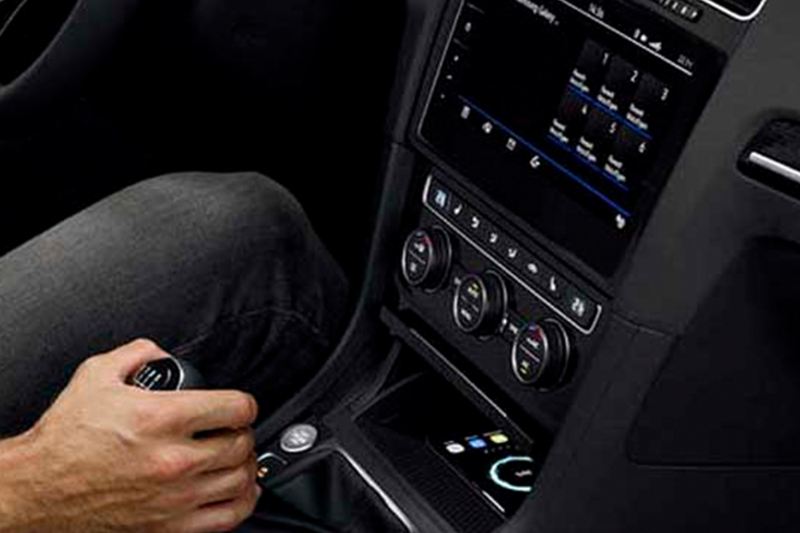 A person changing gears inside their Volkswagen Golf.