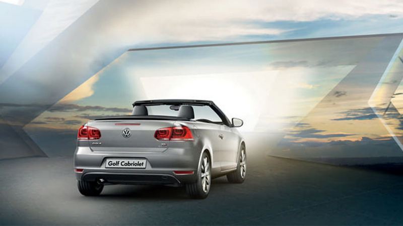 Rear view of a silver Volkswagen Golf Cabriolet, with the roof down.