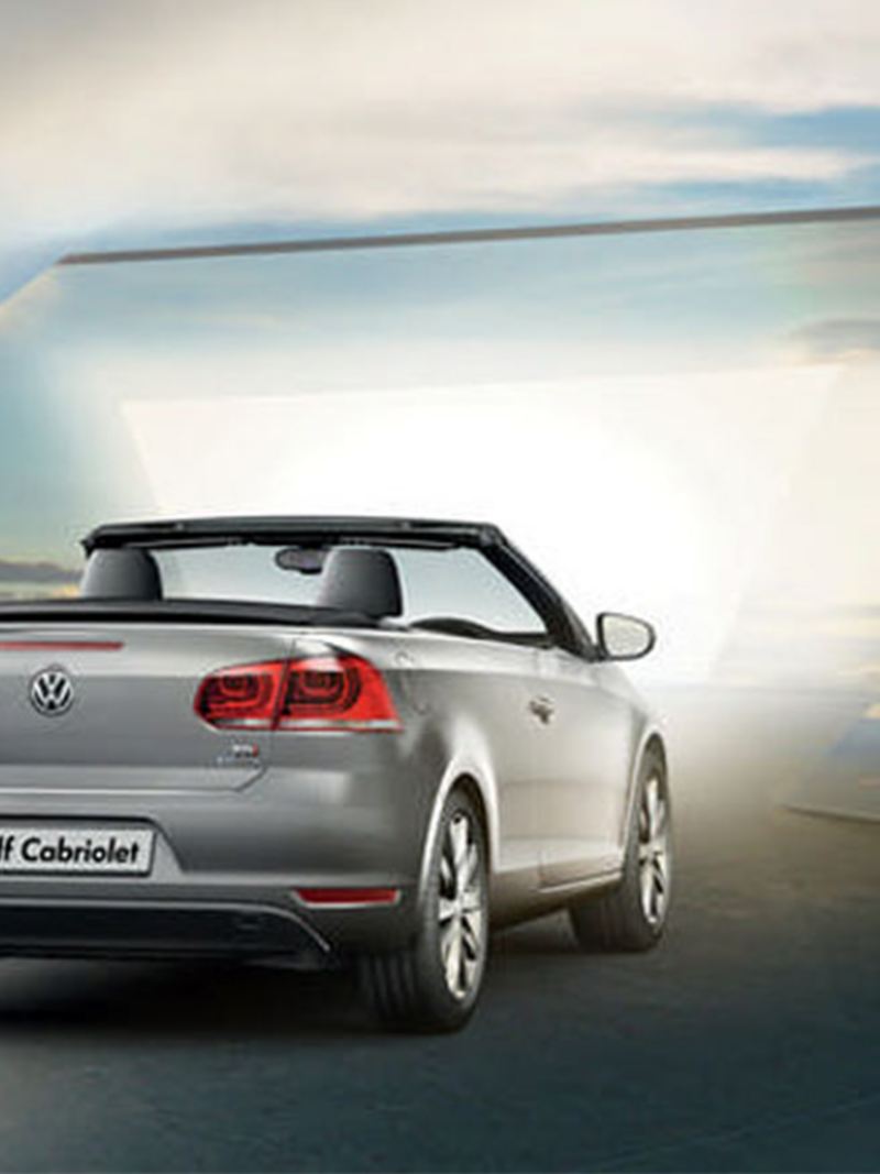Rear view of a silver Volkswagen Golf Cabriolet, with the roof down.