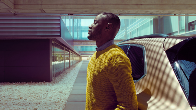 Man standing in front of a Volkswagen car