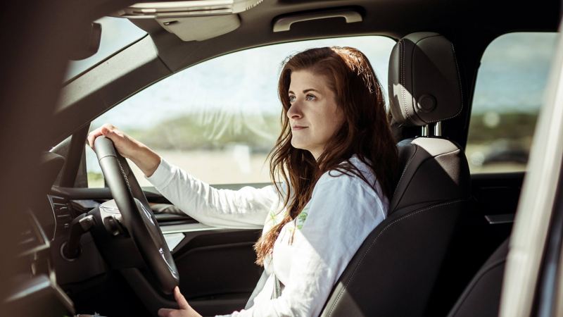 A woman driving a Touareg