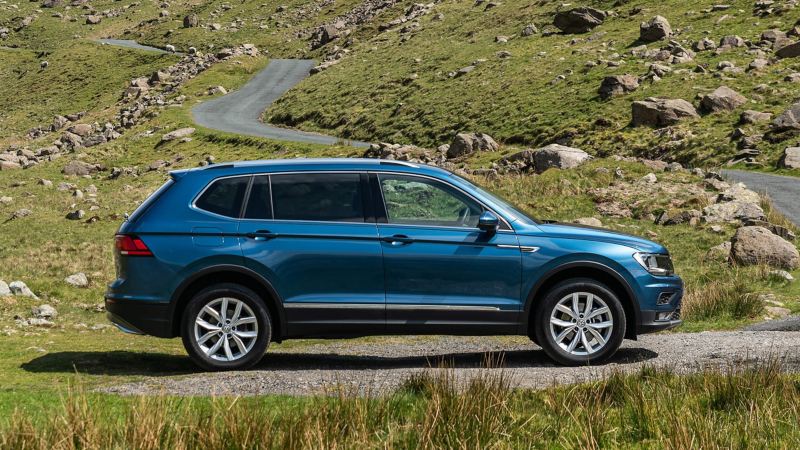 Side view of a VW Tiguan Allspace on a rocky mountainous road