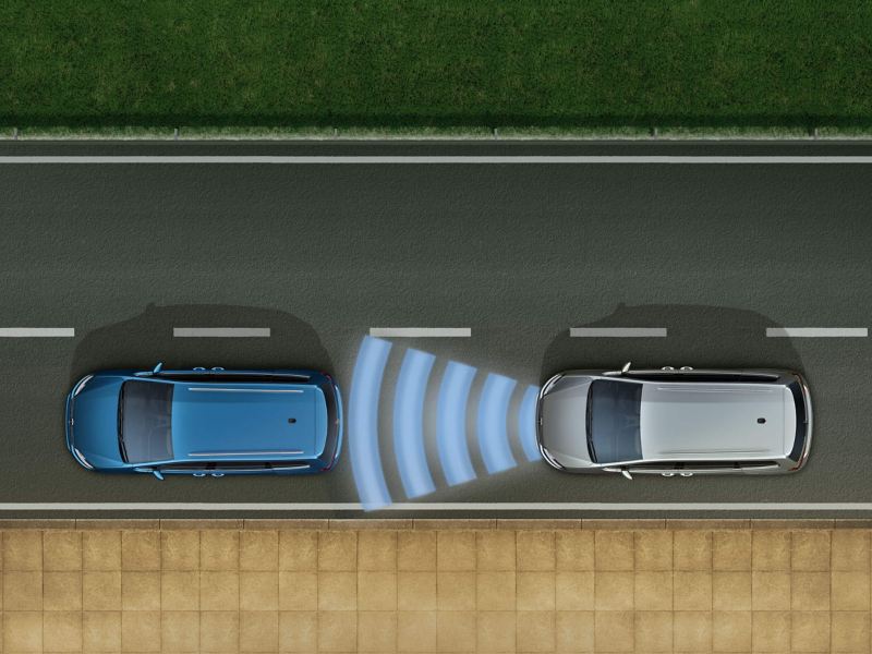 A silver Volkswagen Touran with the Adaptive Cruise Control on while driving behind a blue Volkswagen Touran