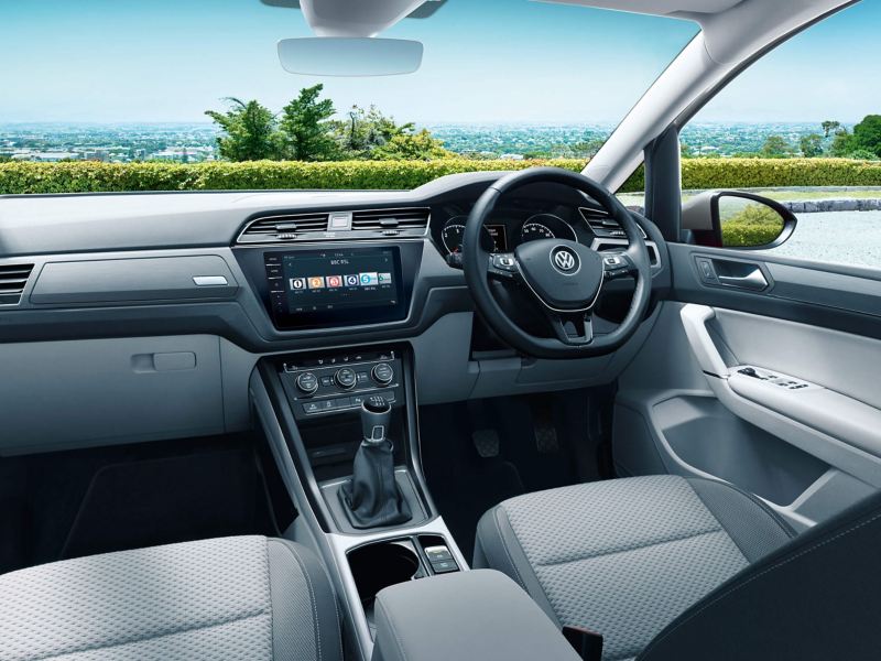 Volkswagen Touran interior with the front seats, steering wheel, dashboard and the centre console showing the Composition Colour Radio