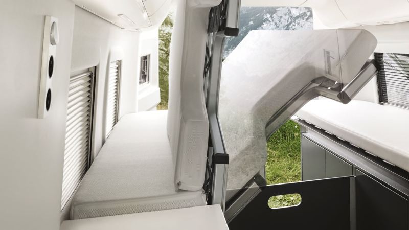 Folding bed showing storage space in VW Grand California motorhome