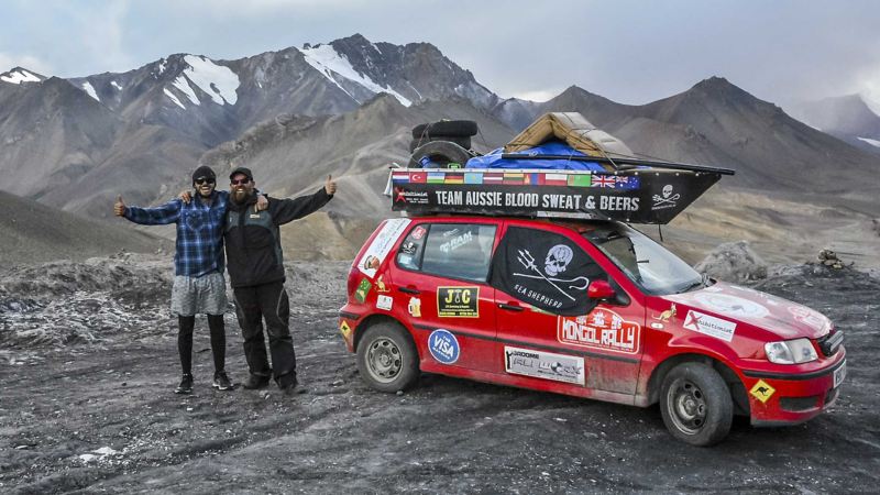 Twee mannen met duim omhoog naast hun Volkswagen Polo 3. tijdens de Polo Rally Mongol