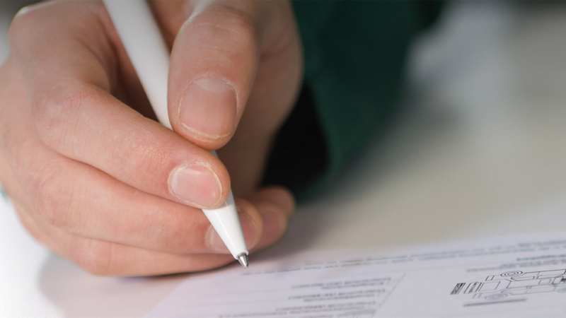 VW technician signing vehicle inspection sheet