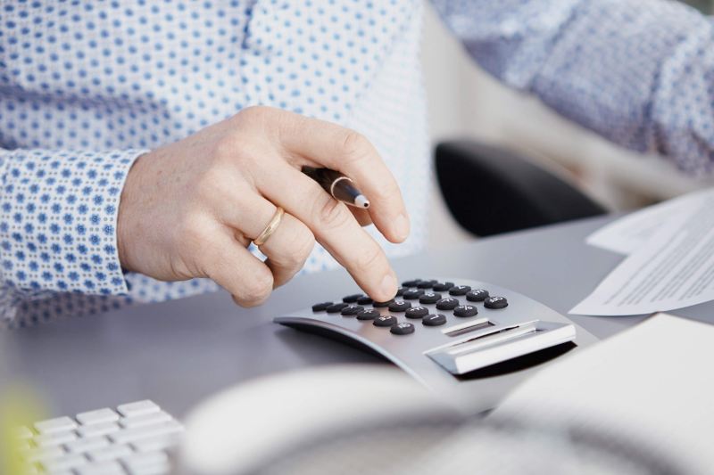 Dealer in VW van centre with calculator on desk