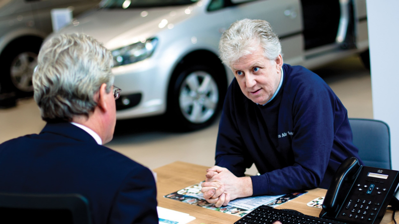 Car dealer and customer at Van Centre desk