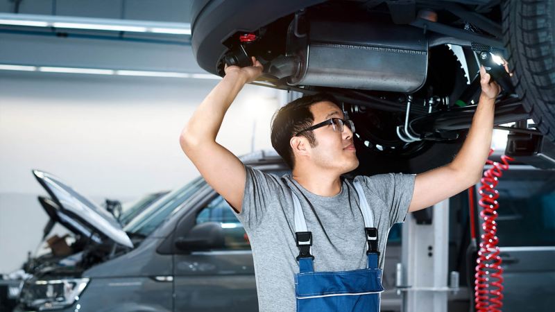 mechanic working on an exhaust in a Van Centre