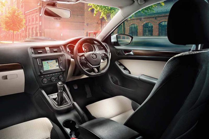 Interior shot of a Volkswagen Jetta, steering wheel and dashboard.