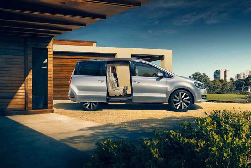 Profile shot of a silver Volkswagen Sharan, the side passenger door open.