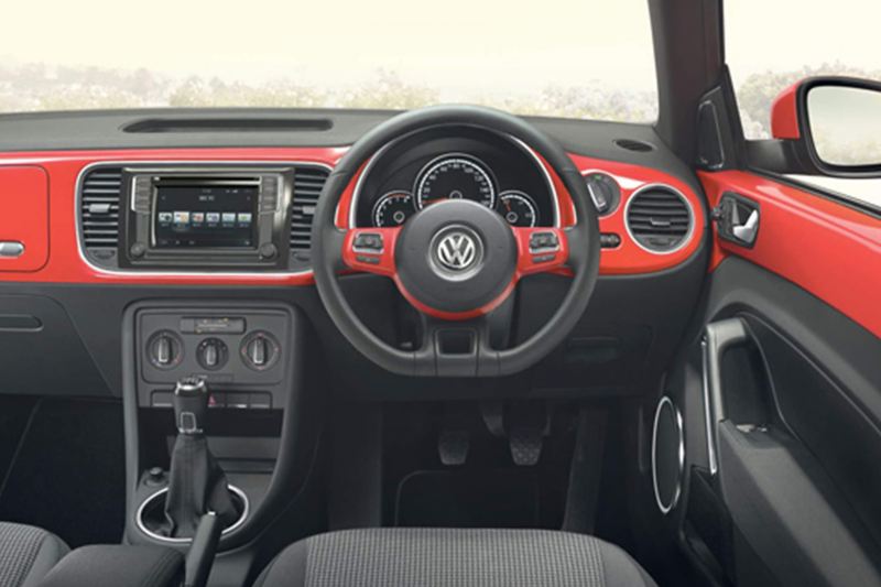 Dashboard and steering wheel shot of the Volkswagen Beetle.