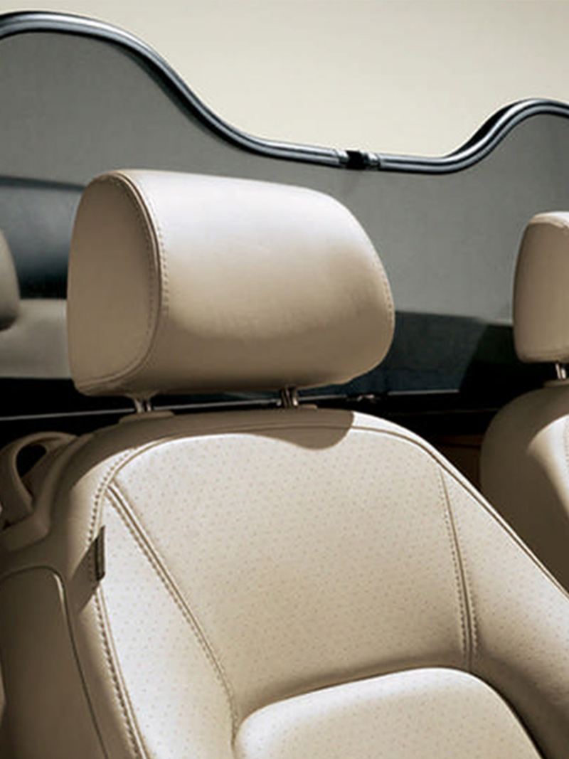Interior shot of the front and rear seats of a Volkswagen Beetle Cabriolet.