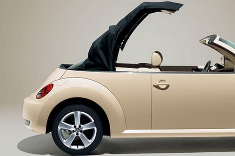 Profile shot of a cream Volkswagen Beetle Cabriolet, the roof opening.