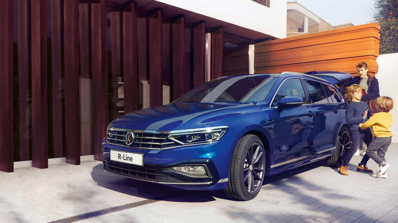 A family getting into a blue Volkswagen Passat Estate