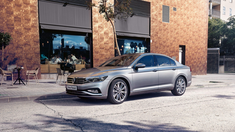 A silver Passat parked in front of a restaurant