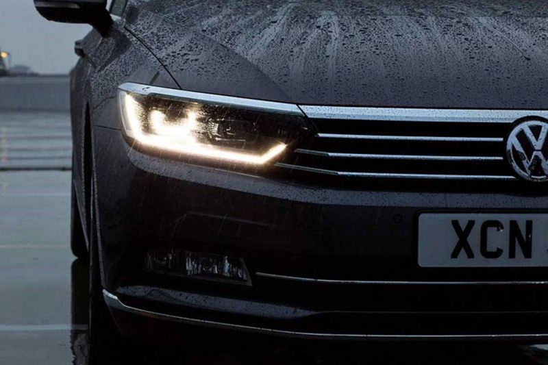 Front headlight shot of a black Volkswagen Passat.