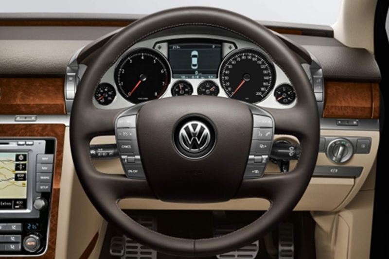 Interior shot of a Volkswagen Phaeton, steering wheel and dashboard.