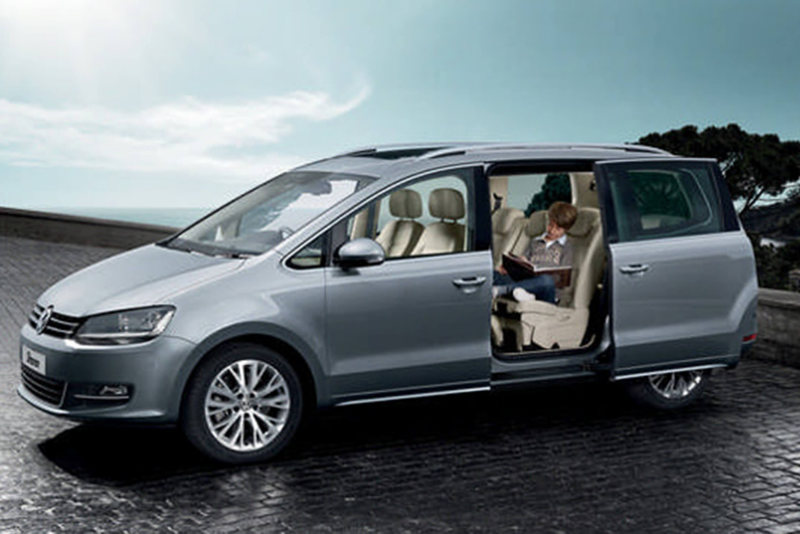 Profile shot of a silver Volkswagen Sharan, the side passenger door open.