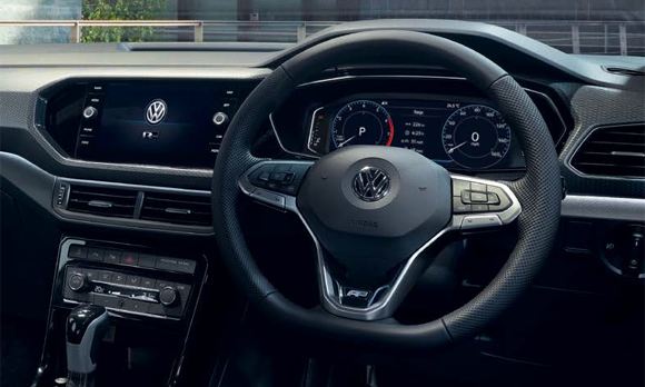 Interior shot of a Volkswagen T-Cross, steering wheel and dashboard.
