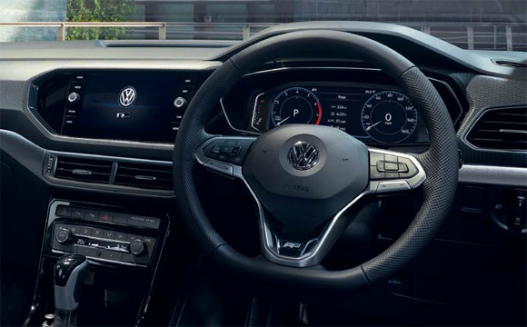 Interior shot of a Volkswagen T-Cross, steering wheel and dashboard.