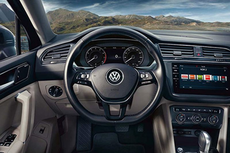Interior shot of a Volkswagen Tiguan Allspace, steering wheel and dashboard.