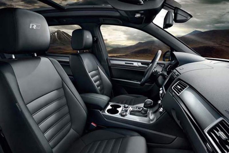 Front seat interior shot of a Volkswagen Touareg, mountains in the background.