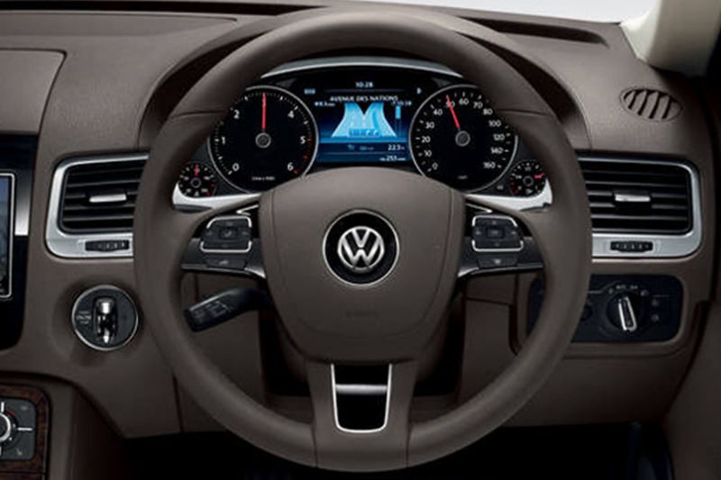 Interior shot of a Volkswagen Touareg, steering wheel and dashboard.